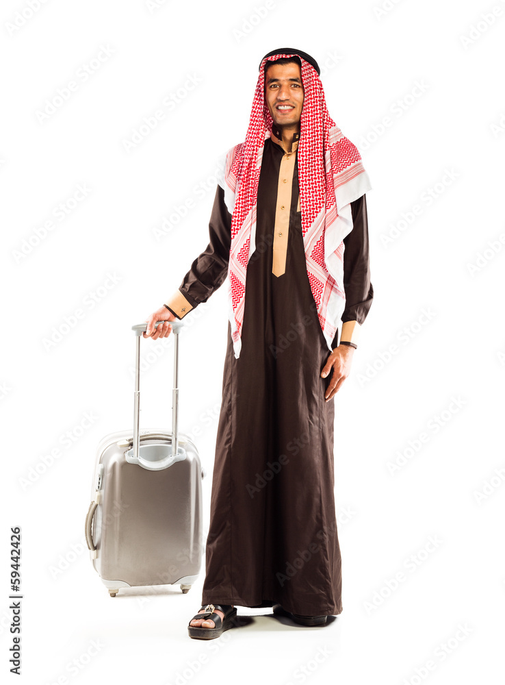 Young smiling arab with a suitcase isolated on white