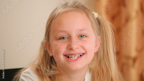 Happy girl laughing with braces on teeth