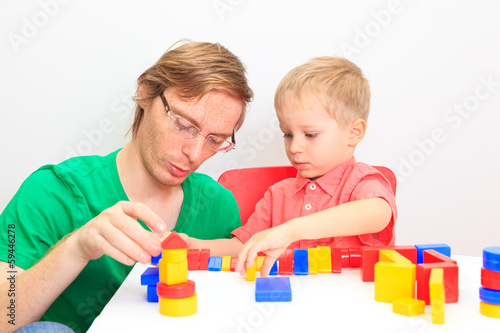 Father and son playing with colorful blocks