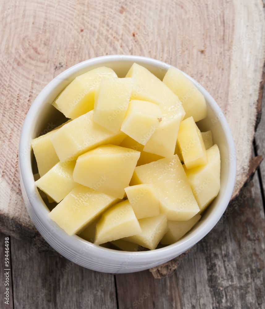 cut raw potatoes in bowl cut raw potatoes in bowl