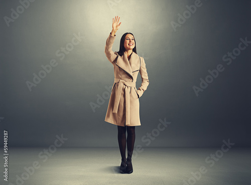 excited young woman waving hand