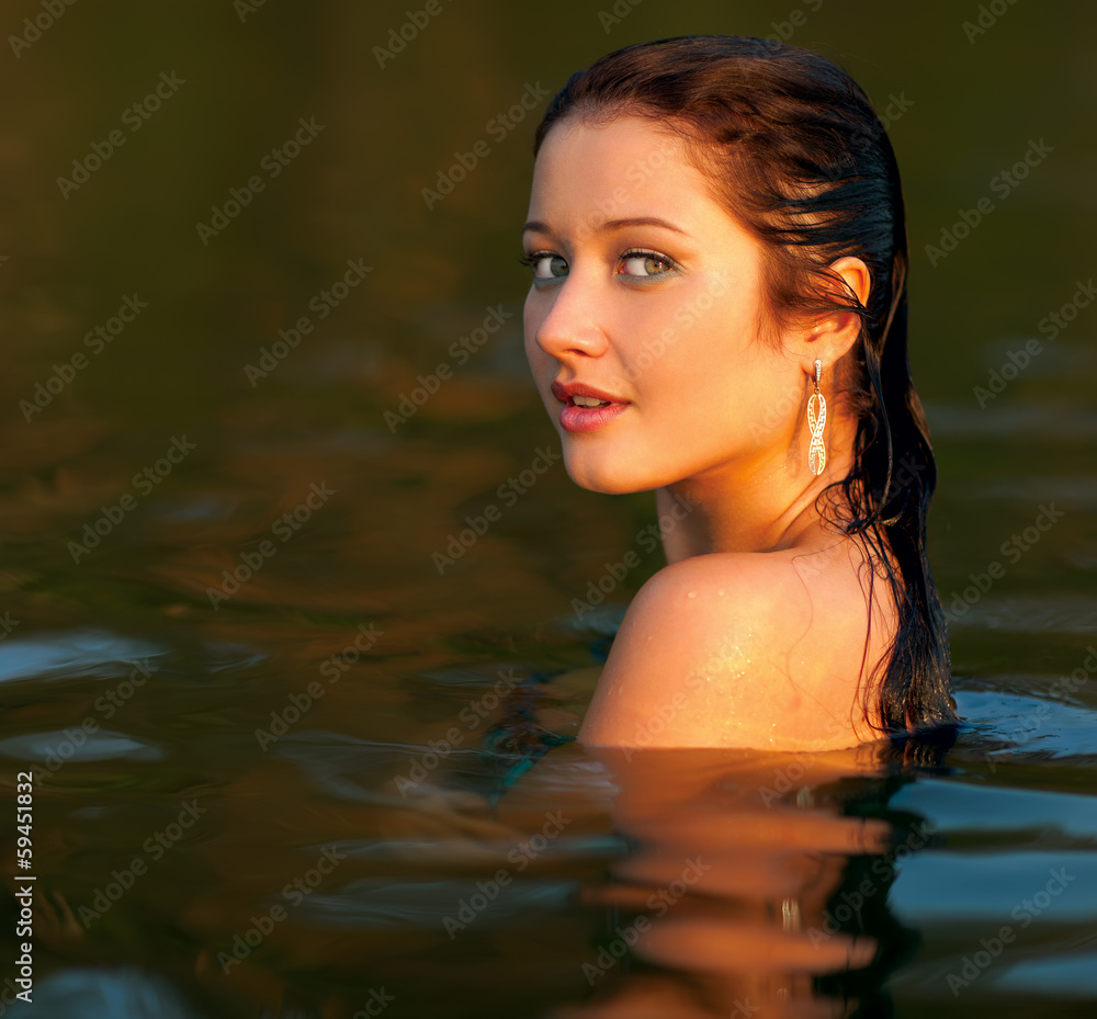 Portrait of a beautiful girl in the water