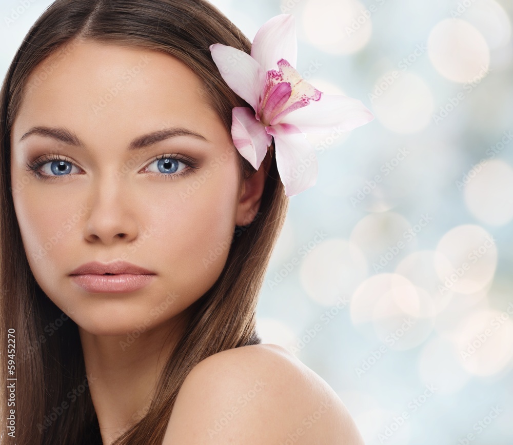 Beautiful young girl with lily flower in her hair Beautiful young girl with lily flower in her hair