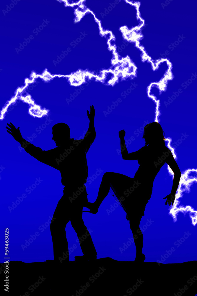 silhouette woman kicking man