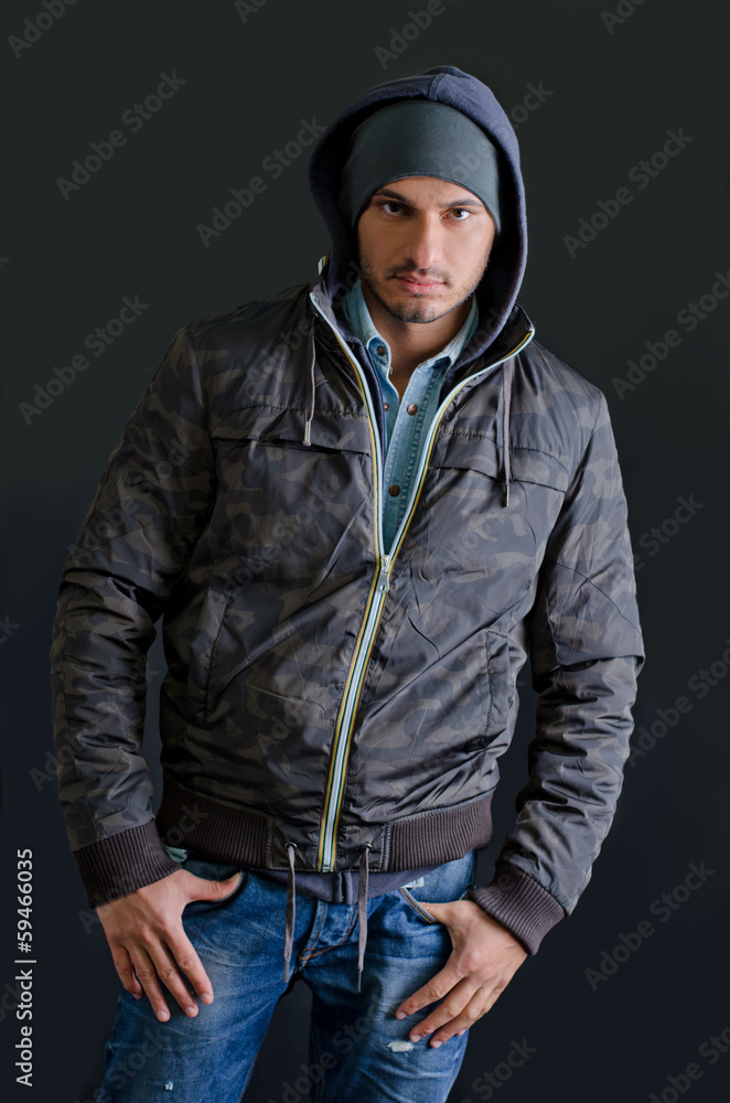 Trendy young man in winter clothes, studio shot Trendy young man in winter clothes, studio shot