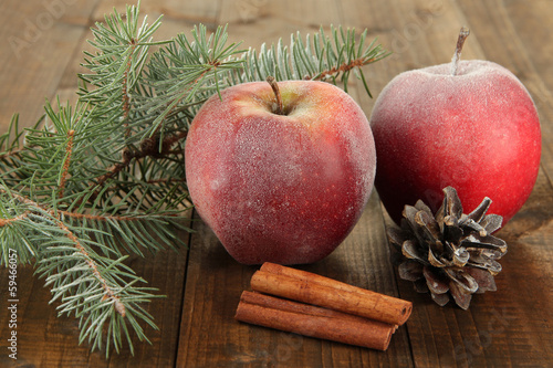 Red frosted apples with fir branch and bumps