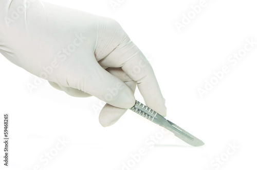 Scalpel in a hand with rubber glove