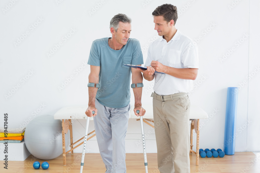 Therapist discussing reports with a disabled patient Therapist discussing reports with a disabled patient