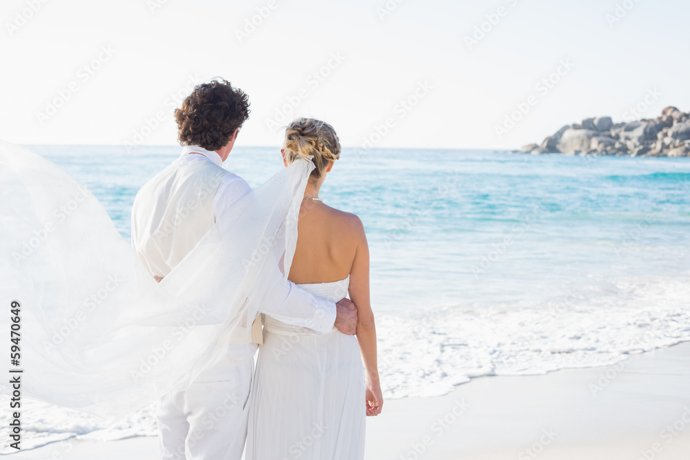 Newlyweds looking out to the sea together Newlyweds looking out to the sea together