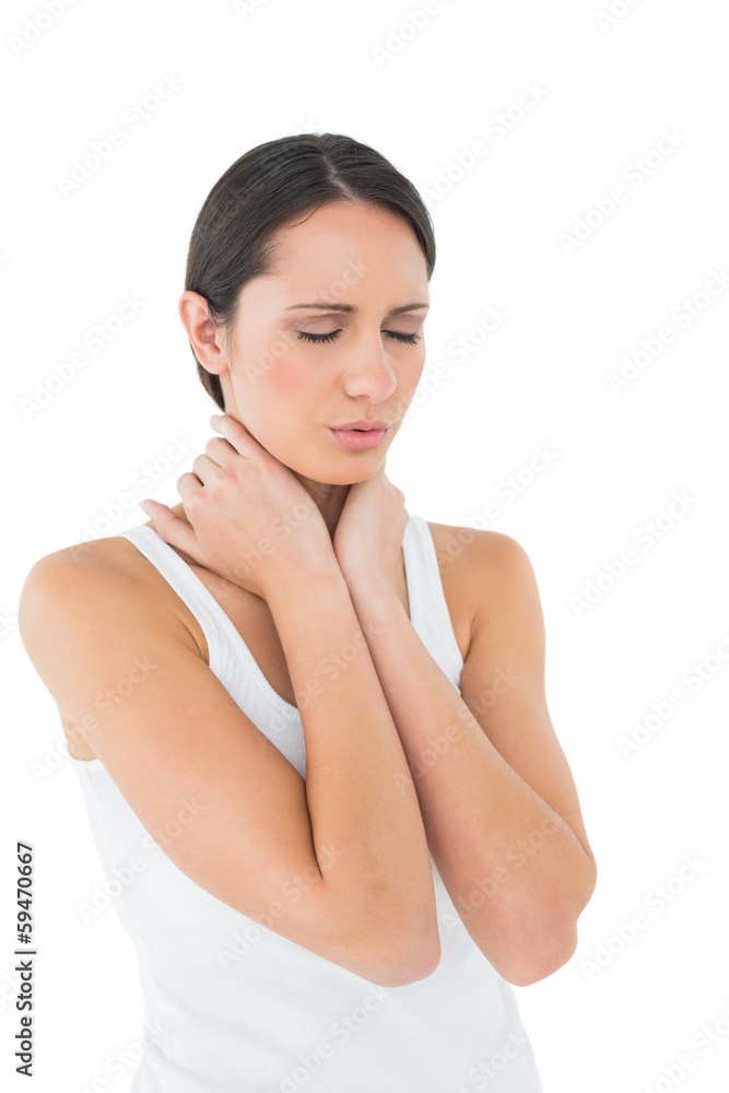 Close-up of a casual woman suffering from neck ache Close-up of a casual woman suffering from neck ache