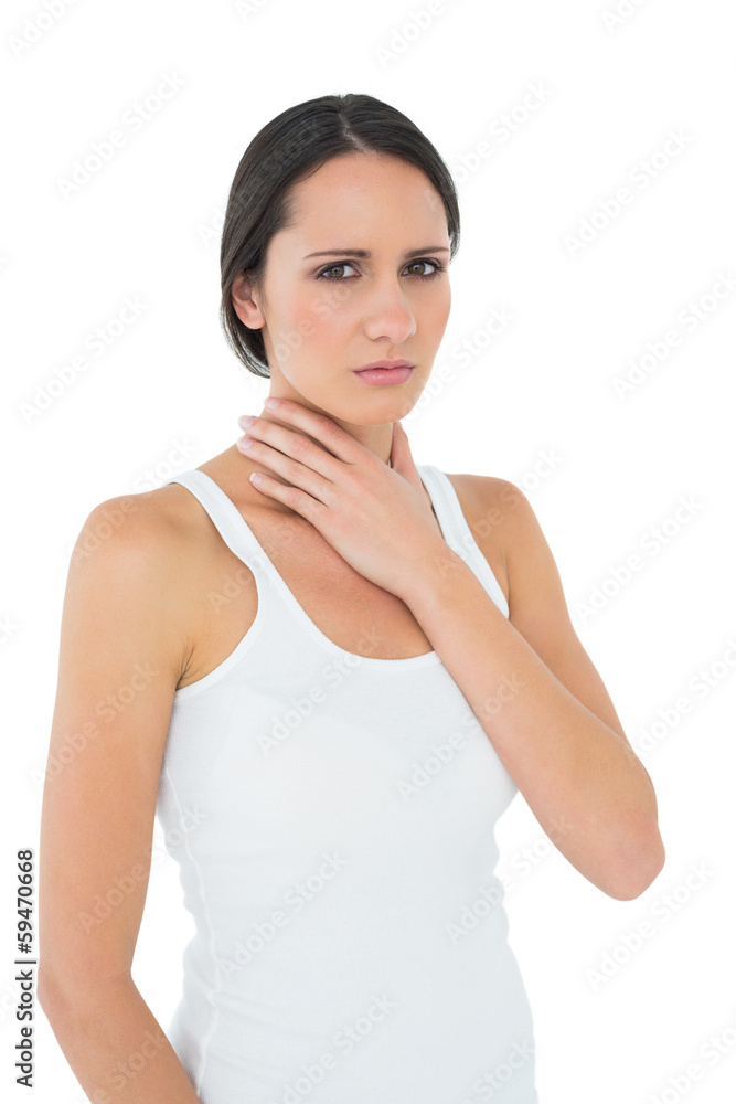 Portrait of a casual woman suffering from neck ache Portrait of a casual woman suffering from neck ache