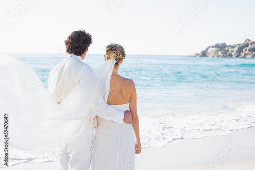 Newlyweds looking out to the sea together © lightwavemedia