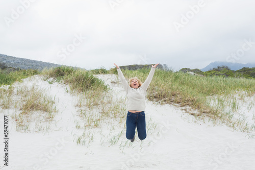 Senior woman jumping at beach © lightwavemedia