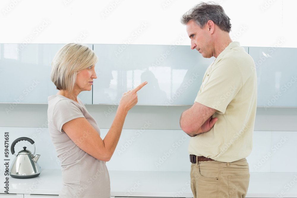 Fototapeta premium Angry couple arguing in kitchen