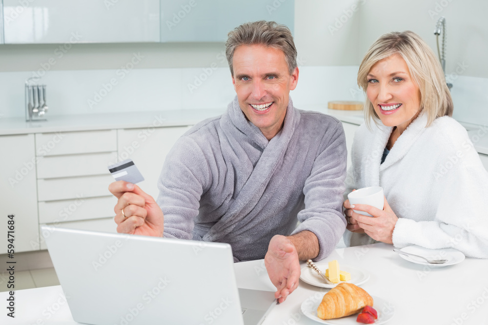 Couple doing online shopping in kitchen Couple doing online shopping in kitchen