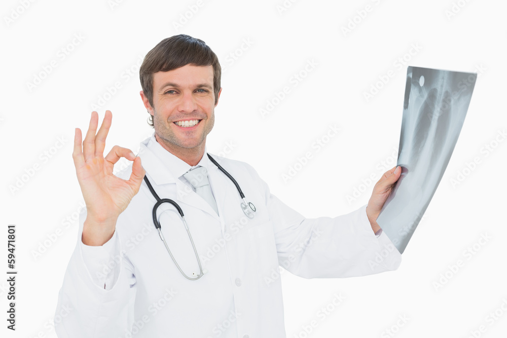 Smiling male doctor holding an x-ray picture of lungs Smiling male doctor holding an x-ray picture of lungs