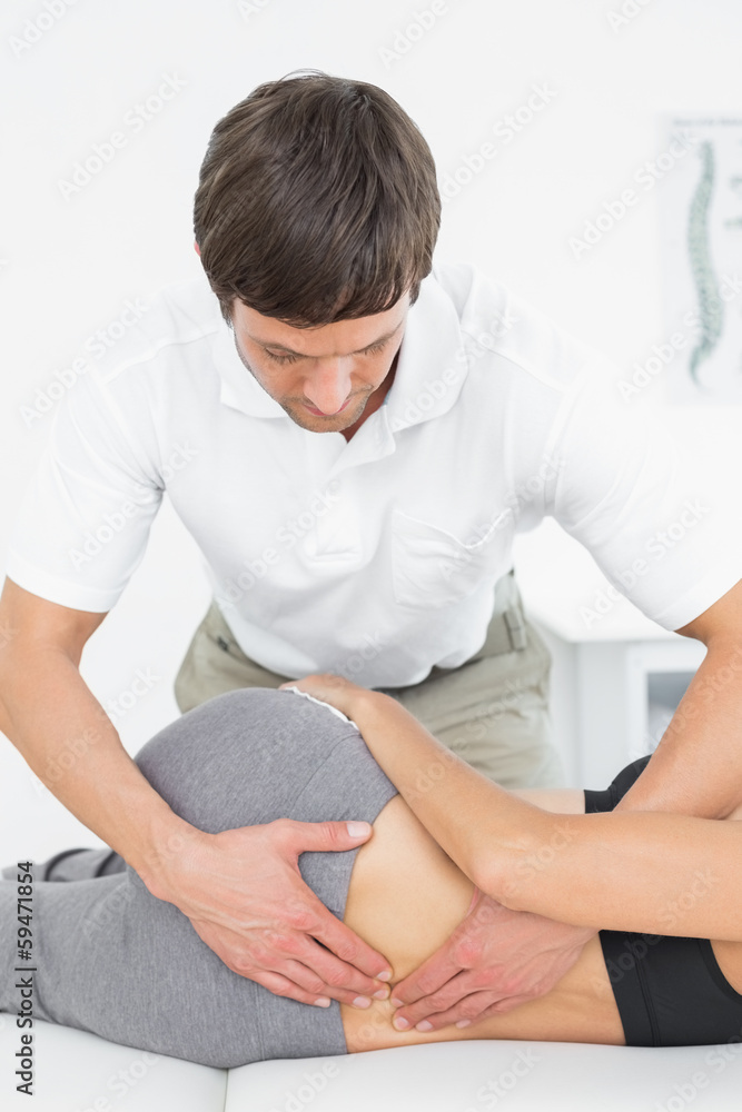 Fototapeta premium Male physiotherapist massaging woman's back