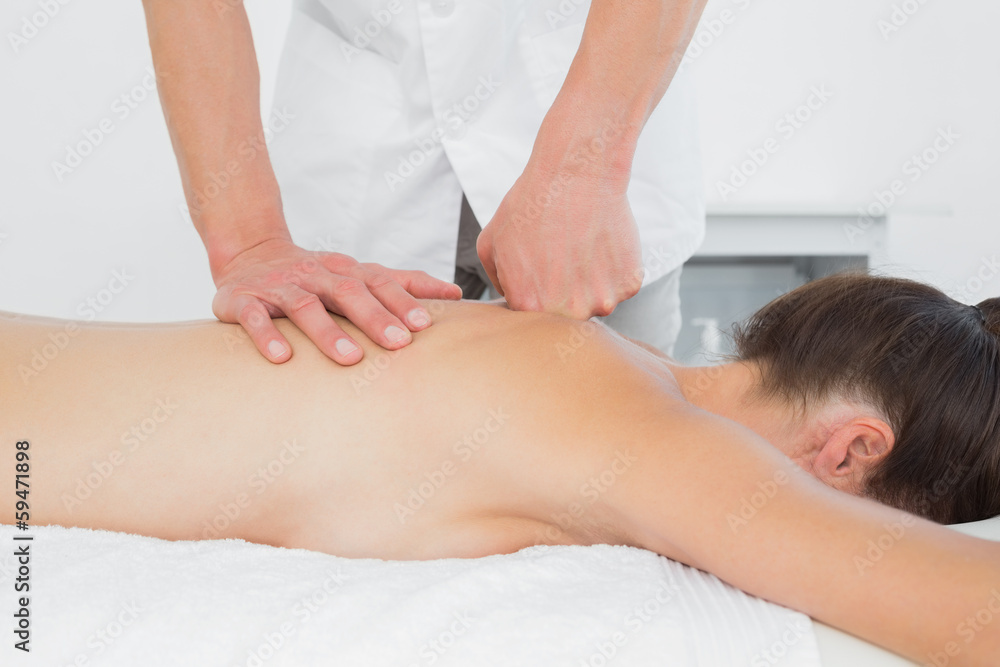 Close-up of a physiotherapist massaging woman's back Close-up of a physiotherapist massaging woman's back