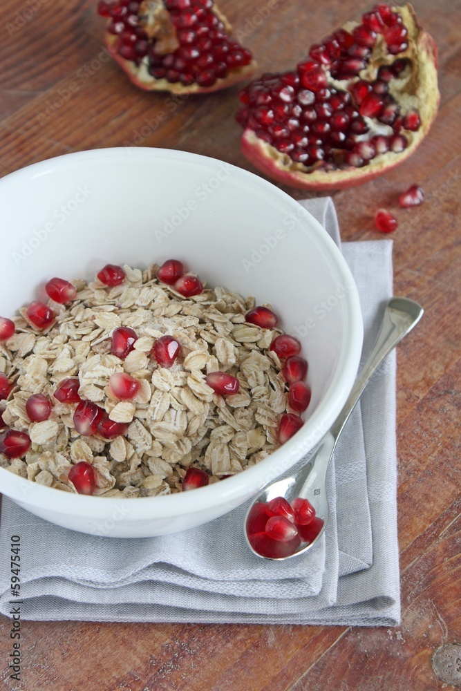 Granola with pomegranate in the white bowl. Granola with pomegranate in the white bowl.
