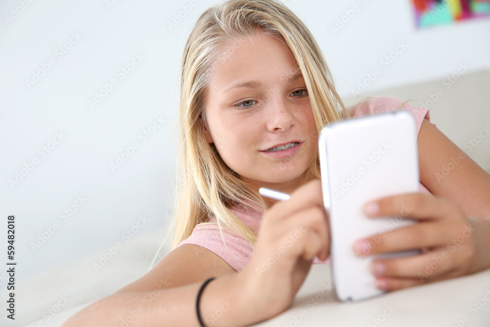 Young girl using smartphone at home Young girl using smartphone at home