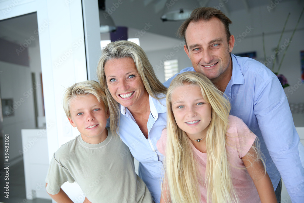 Happy family of four looking at camera Happy family of four looking at camera