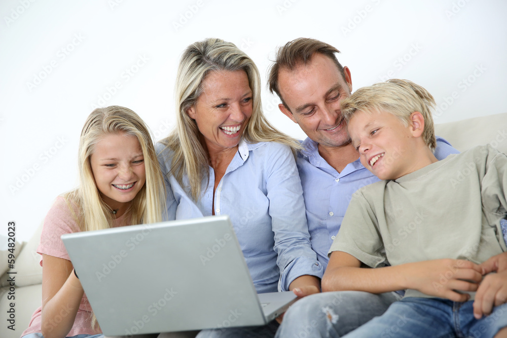 Family connected on internet with laptop Family connected on internet with laptop