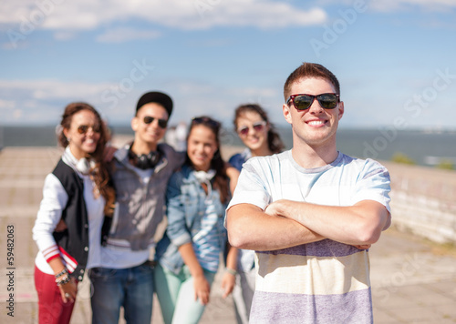 teenage boy with sunglasses and friends outside