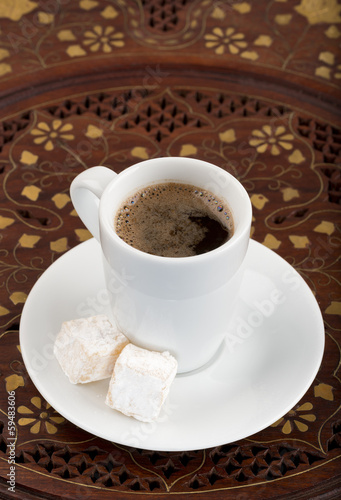 Cup of black turkish coffee on the vintage wooden table. © longtaildog