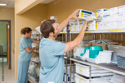 Nurses Arranging Stock In Storage Room