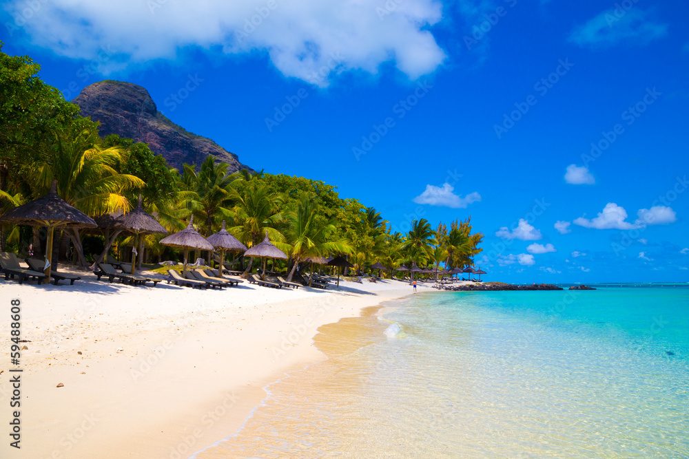 White sandy beach with umbrellas Mauritius