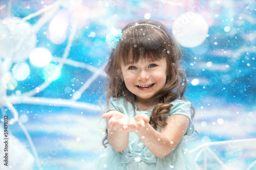 A little girl holding snow