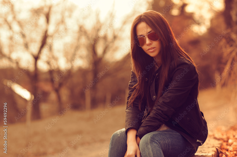 Beautiful female model at sunset. Wearing sunglasses. Outdoor po Beautiful female model at sunset. Wearing sunglasses. Outdoor po
