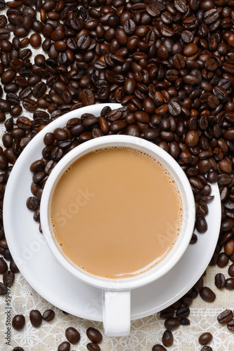 top view of hot coffee cup and beans