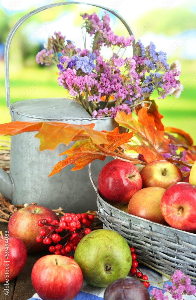 Juicy apples in basket on table on natural background Juicy apples in basket on table on natural background