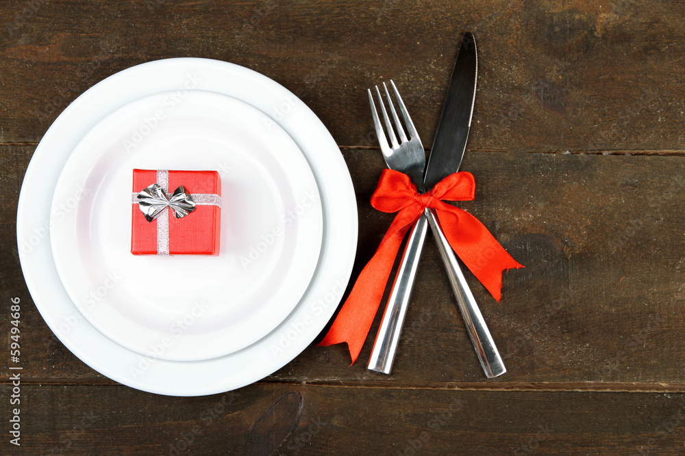 Romantic holiday table setting, on wooden background Romantic holiday table setting, on wooden background