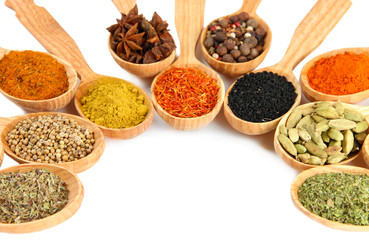 Fototapete Gewürze Assortment of spices in wooden spoons, isolated on white  © Africa Studio
