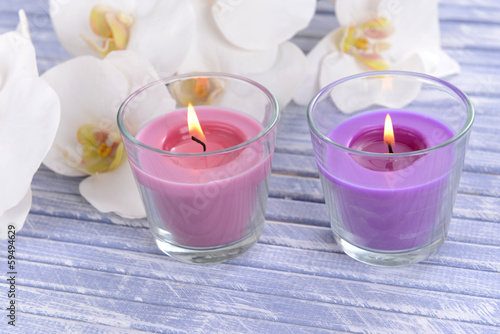 Beautiful colorful candles and  orchid flowers 