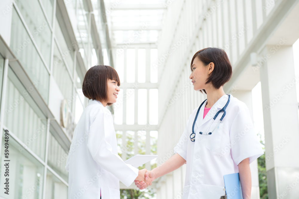 Asian medical doctors shaking hands Asian medical doctors shaking hands