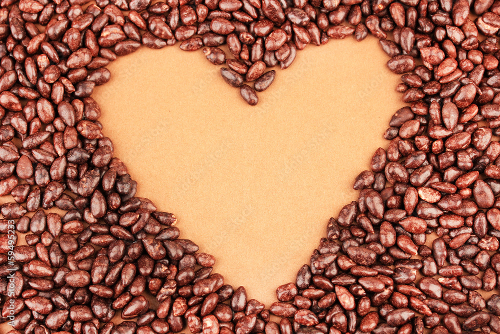 Heart of sunflower grains in chocolate, on brown background Heart of sunflower grains in chocolate, on brown background