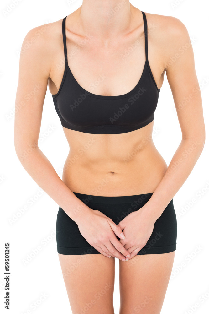 Mid section of a fit woman in black sportswear Mid section of a fit woman in black sportswear