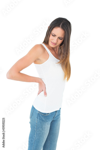 Casual young woman suffering from back pain