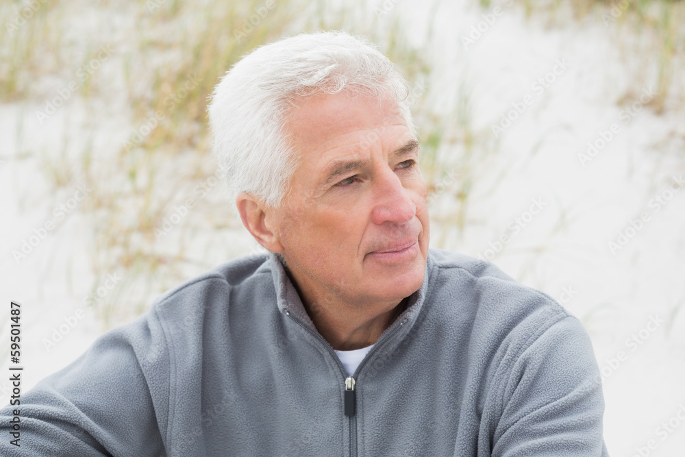 Smiling casual senior man relaxing at beach Smiling casual senior man relaxing at beach