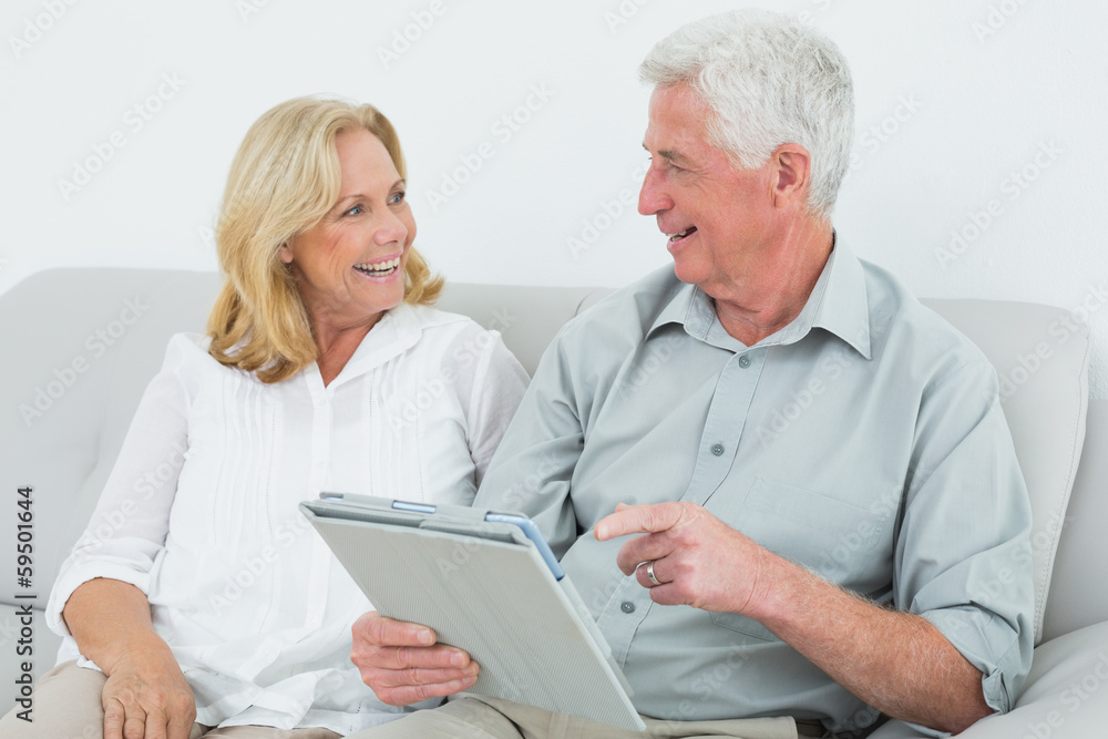 Relaxed senior couple using digital tablet at home Relaxed senior couple using digital tablet at home