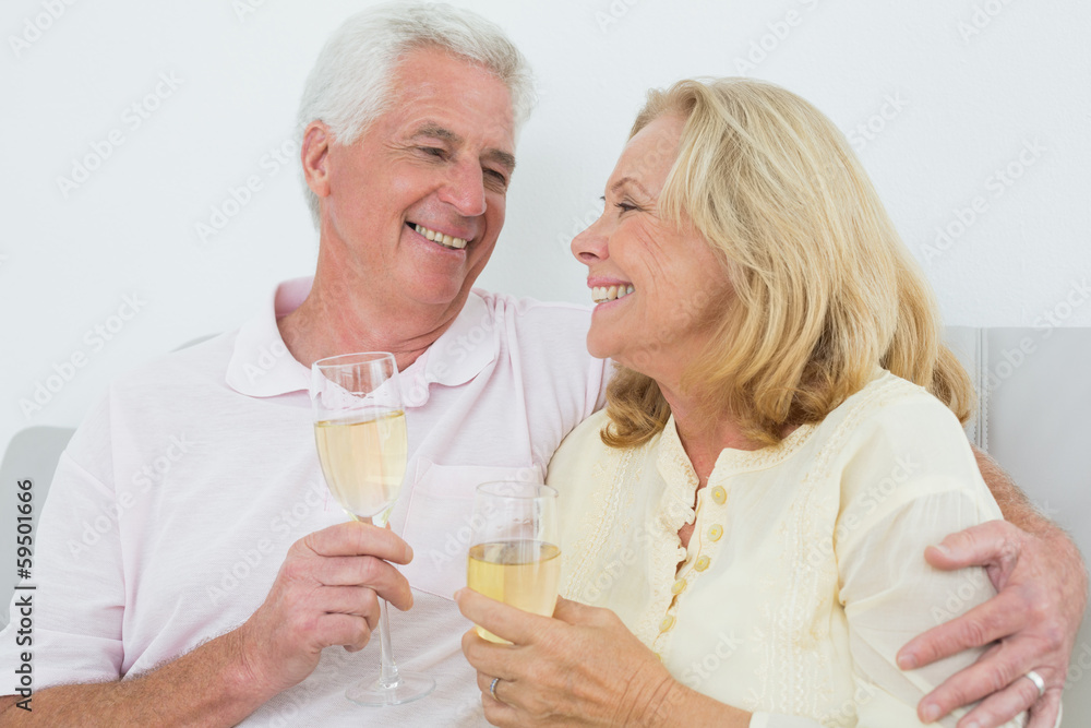 Senior couple with champagne flutes at home Senior couple with champagne flutes at home
