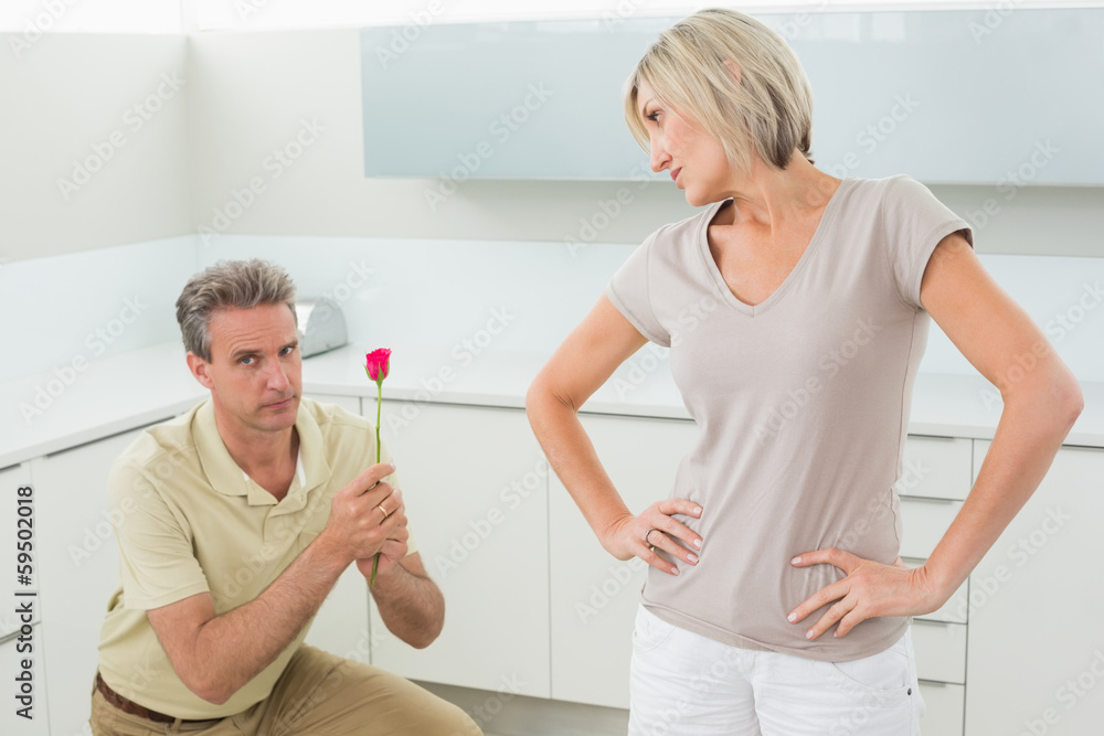 Fototapeta premium Man making a proposal to woman in kitchen