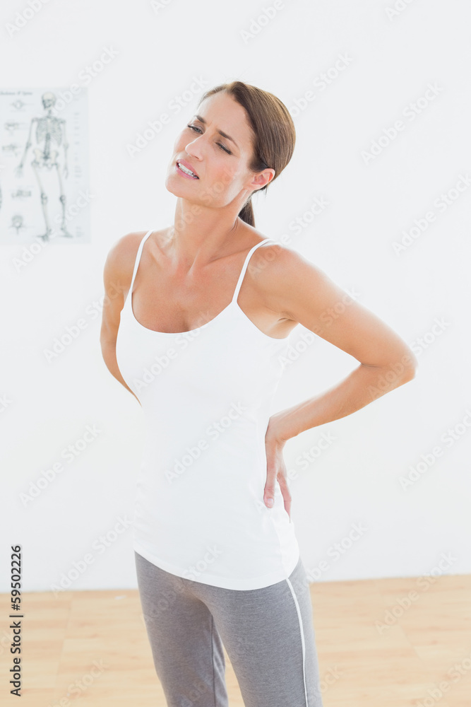 Beautiful young woman with back pain