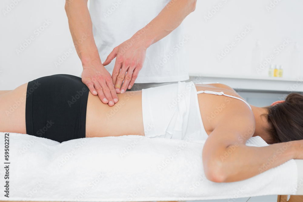 Obraz premium Male physiotherapist massaging woman's back