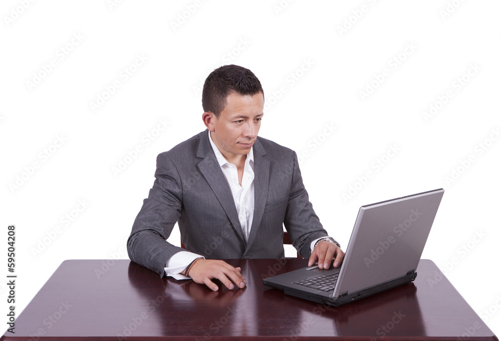 Image of a handsome young businessman using laptop while at work Image of a handsome young businessman using laptop while at work