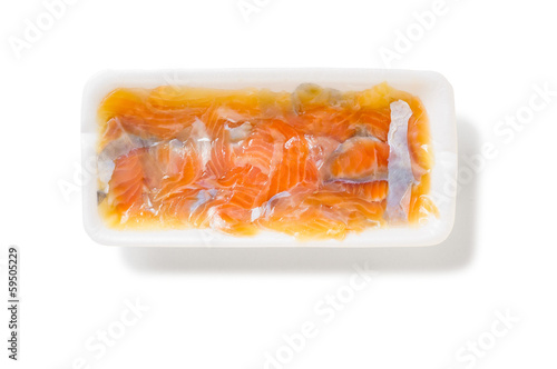 Salt Humpback Salmon (Oncorhynchus gorbuscha) slices in a foam tray, isolated on white background