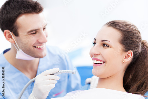 Male dentist and woman in dentist’s office